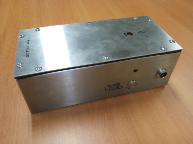 Angled view of the Ozilite ACLBPS enclosure, activation button and resettable fuse