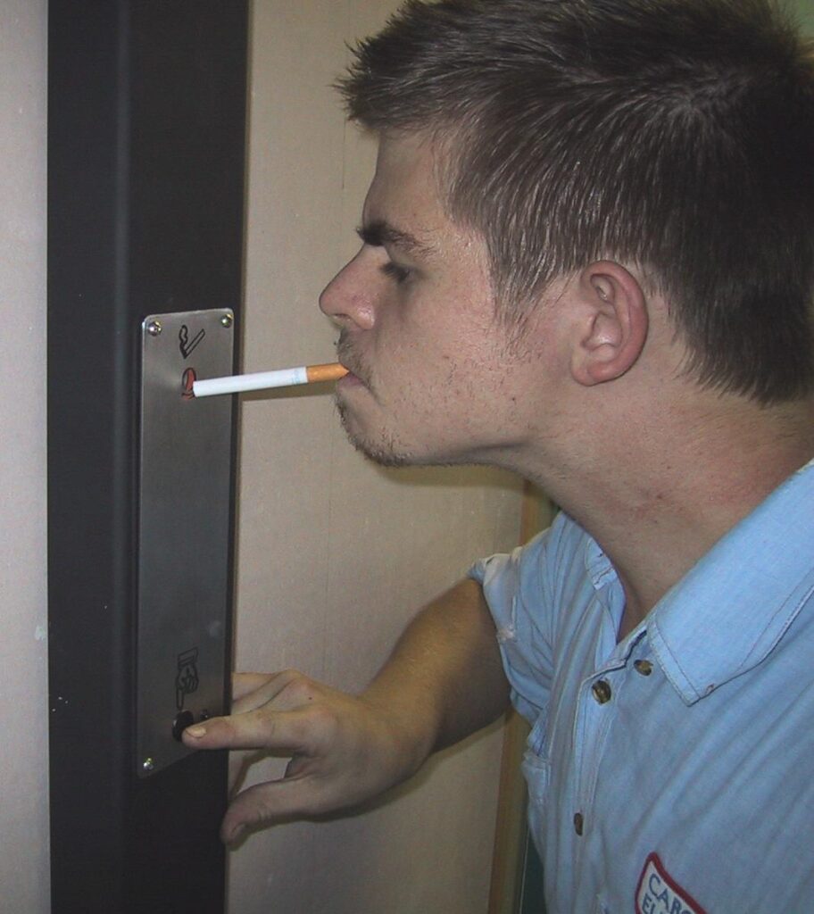Person using an Ozilite ACLST pole-mounted automatic cigarette lighter