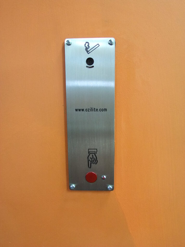 Ozilite ACLST vertical pole-mounted automatic cigarette lighter installed in a post, front view